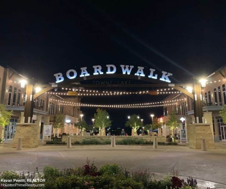 The Boardwalk at Towne Lake illuminated at night, a local landmark in Cypress, Texas