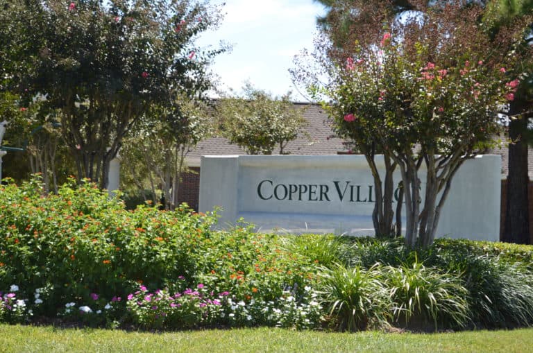 Copper Village brick entrance sign off West Road in Houston, TX 77095