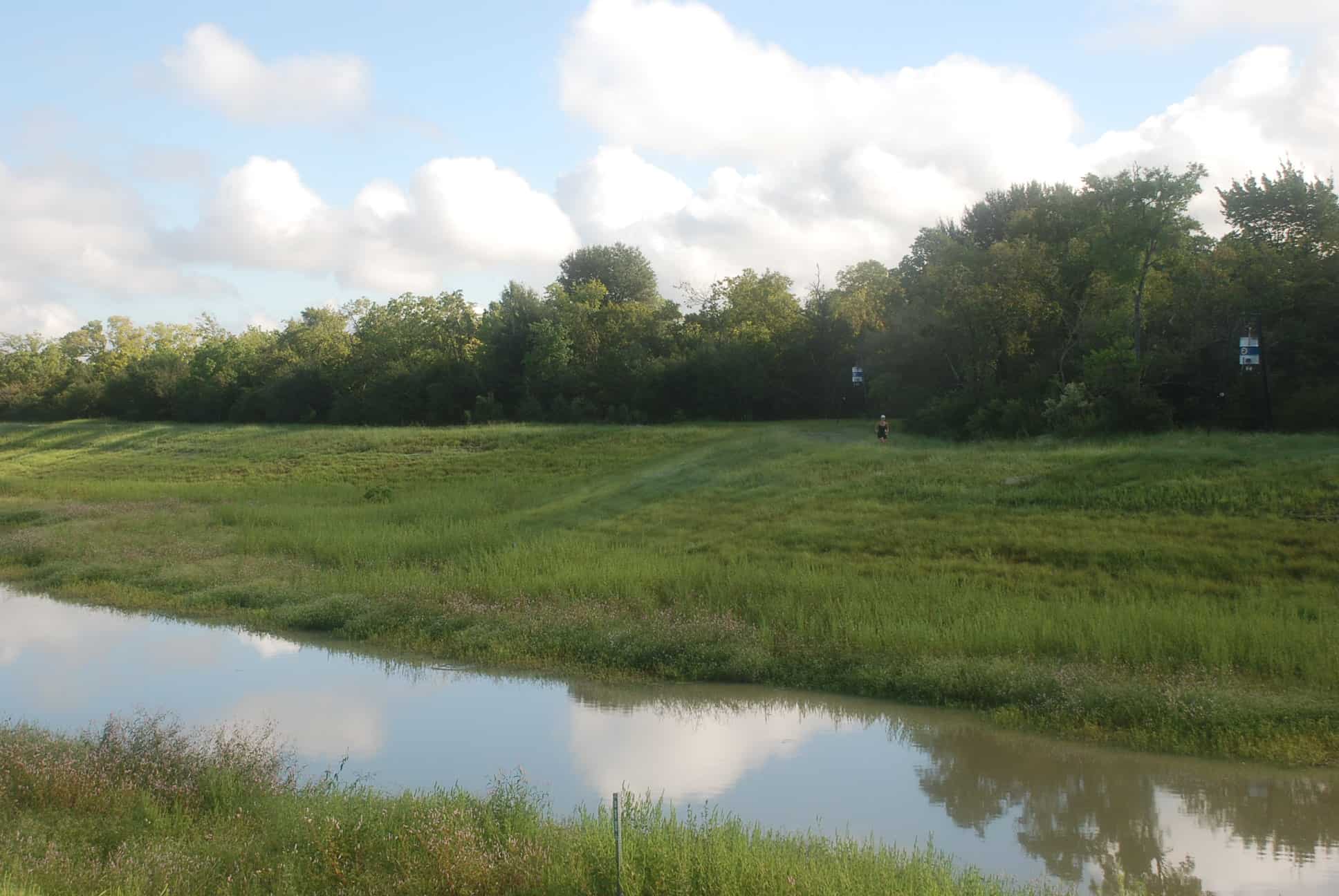 Detention Pond with unimproved section of trail on east side