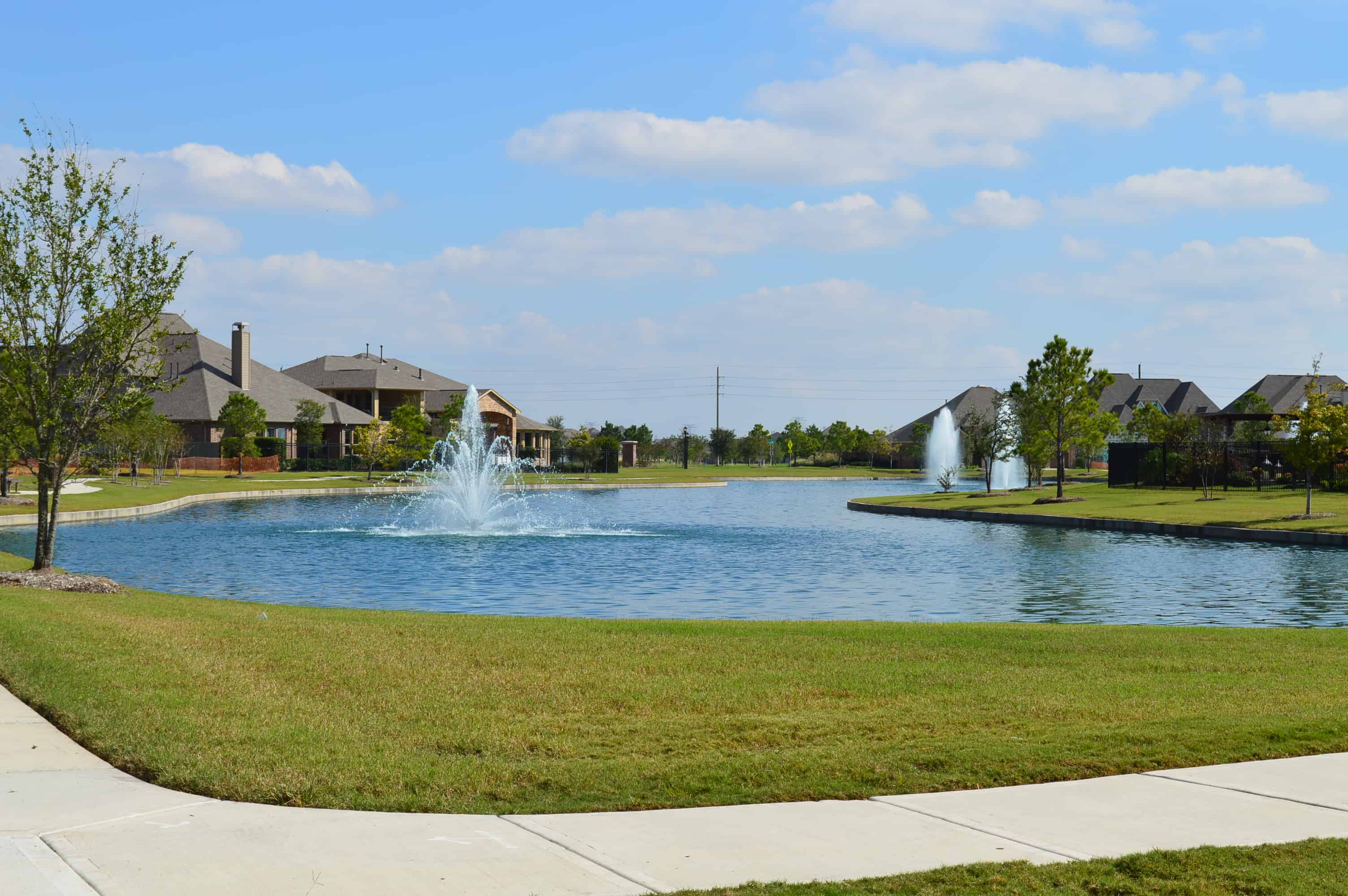 Cypress Creek Lakes Realtor โ a community lake with fountains and homes along the bank in Cypress Creek Lakes, Cypress, TX 77433