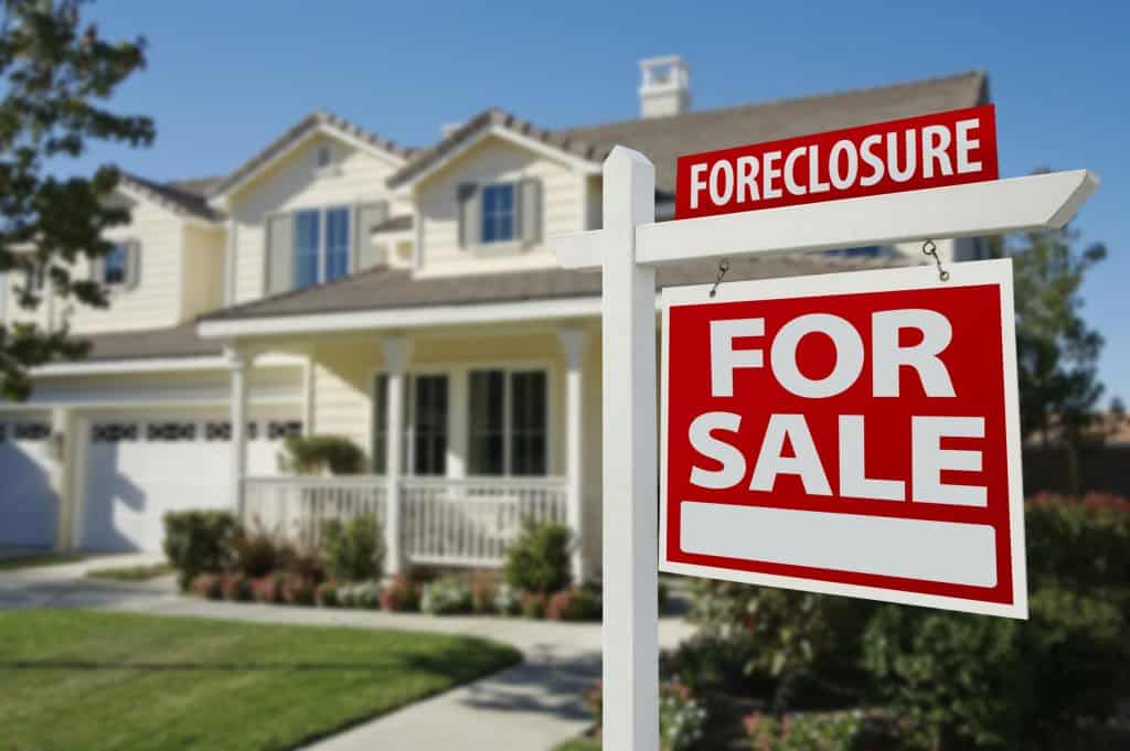 Real estate For Sale sign at a Houston foreclosure or bank-owned home