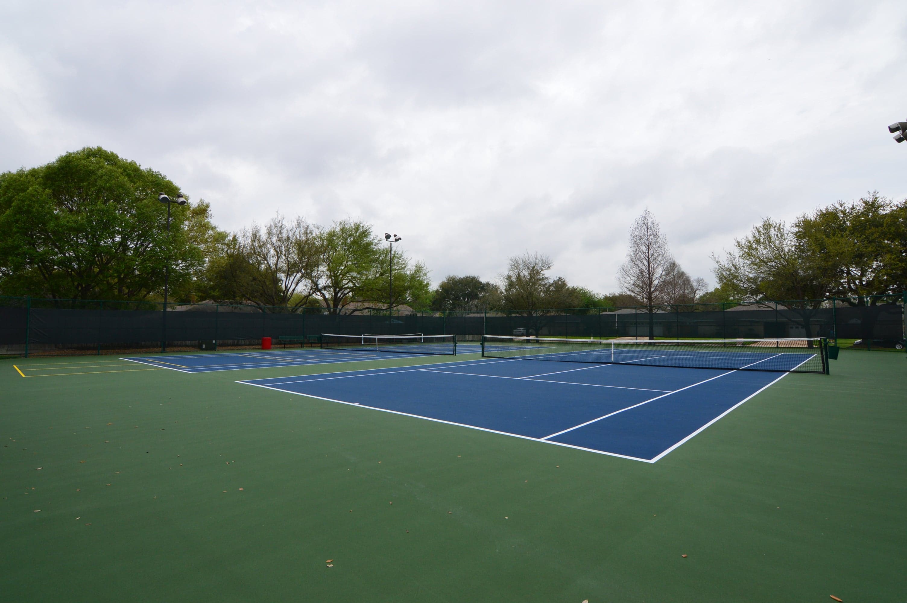 Fenced tennis courts at the Concord Bridge recreation center, Houston TX 77041