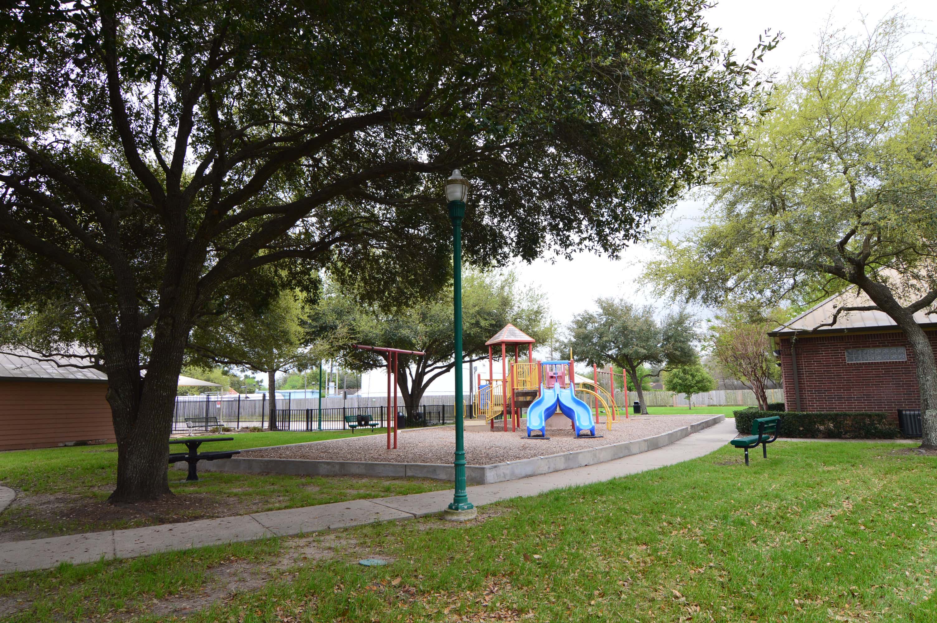Playground under live oaks in Central Bridge Park, Concord Bridge, Houston TX