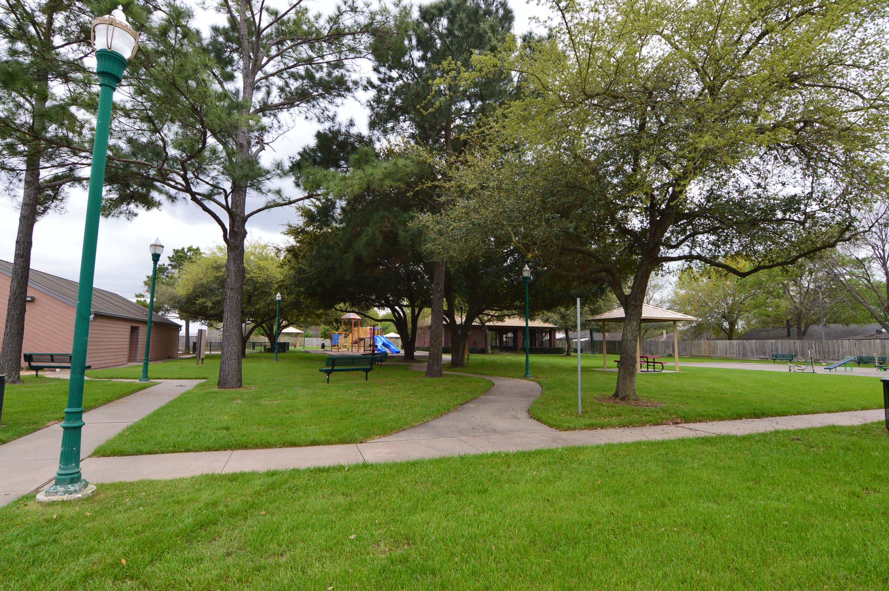 Walking paths, lamp posts and shade trees in Central Bridge Park, Concord Bridge, Houston TX