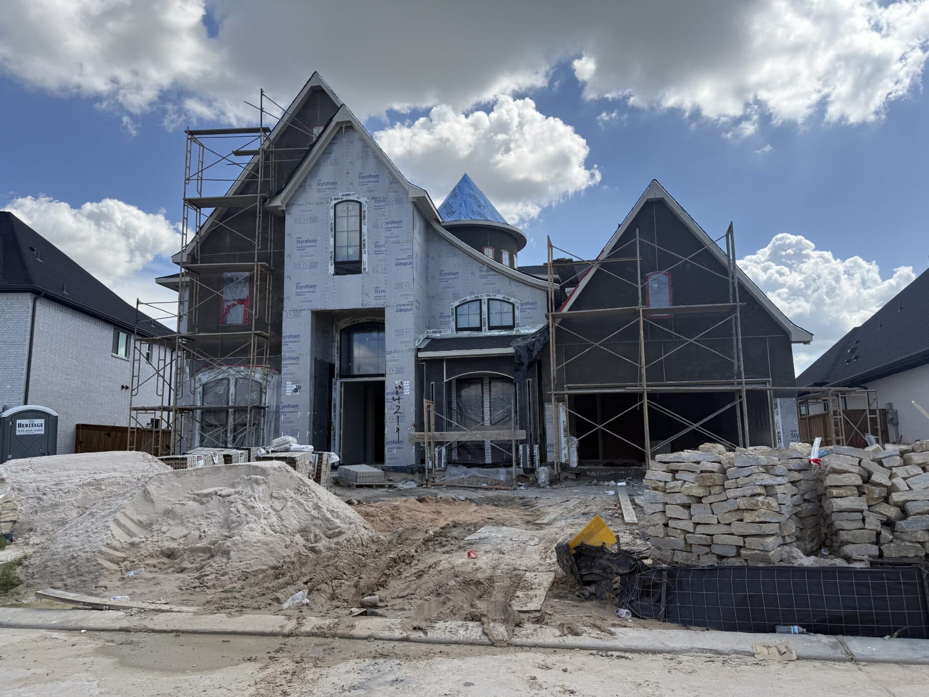 A new Dunham Pointe home under construction at the house-wrap stage — Cypress, TX 77433