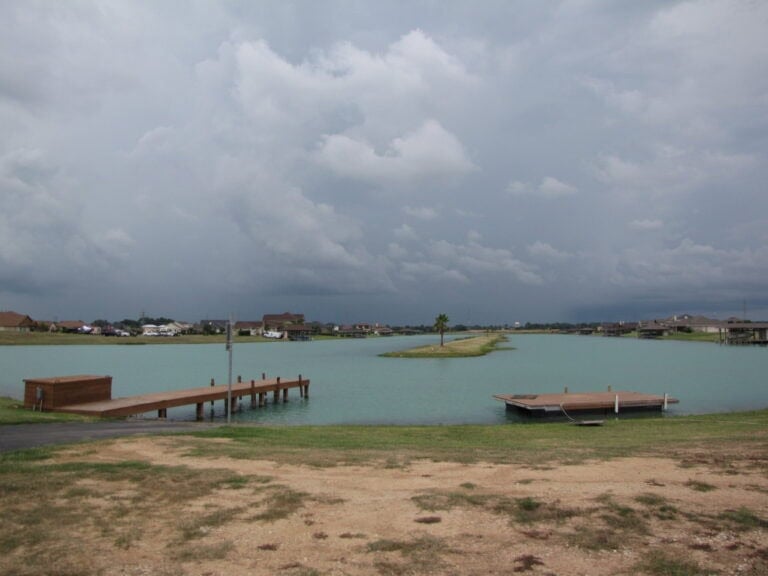 Wooden dock, floating platform and palm island on a Lakes of Katy lake, Katy TX 77493