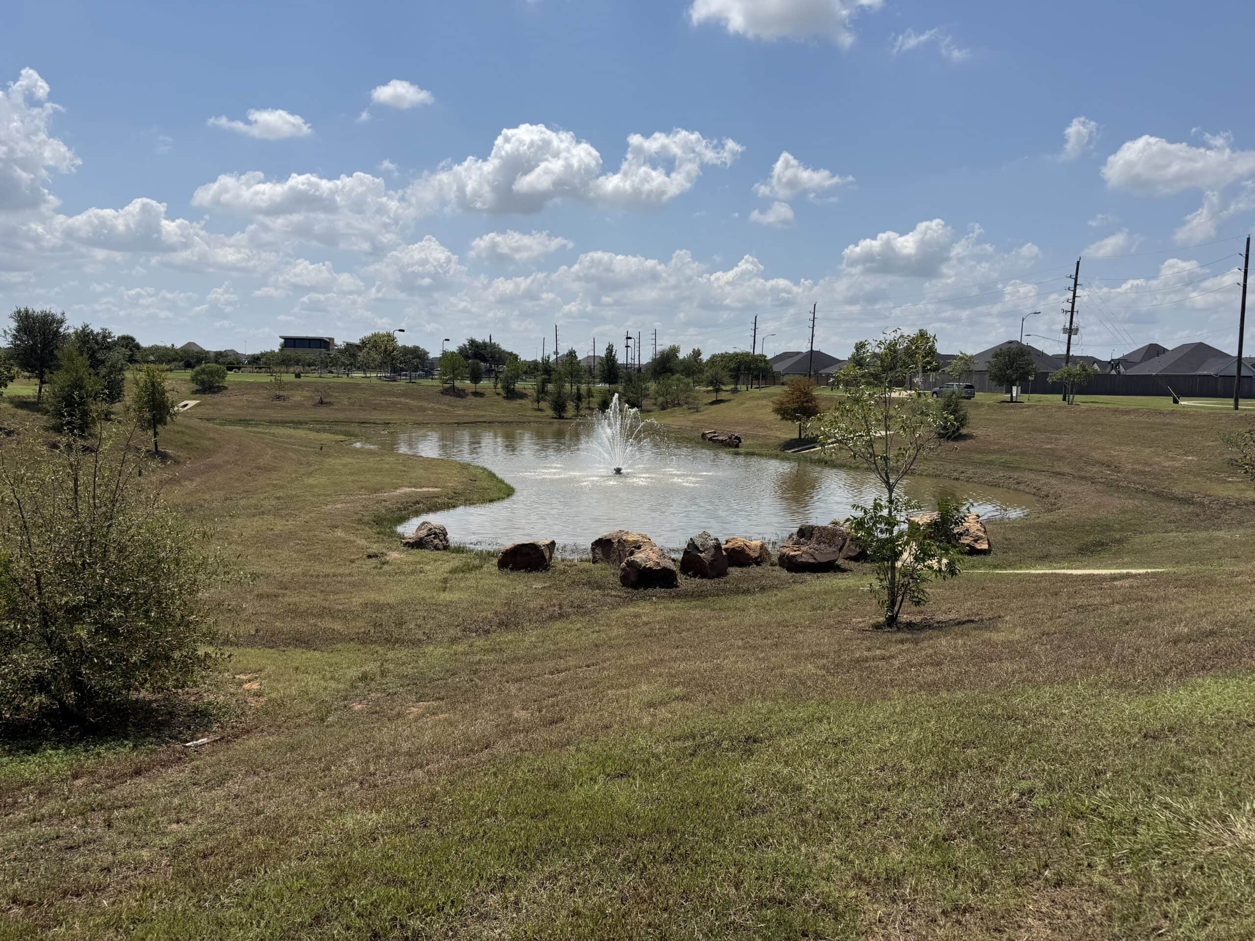 Community amenity lake with a fountain in a new master-planned neighborhood in Hockley, TX 77447