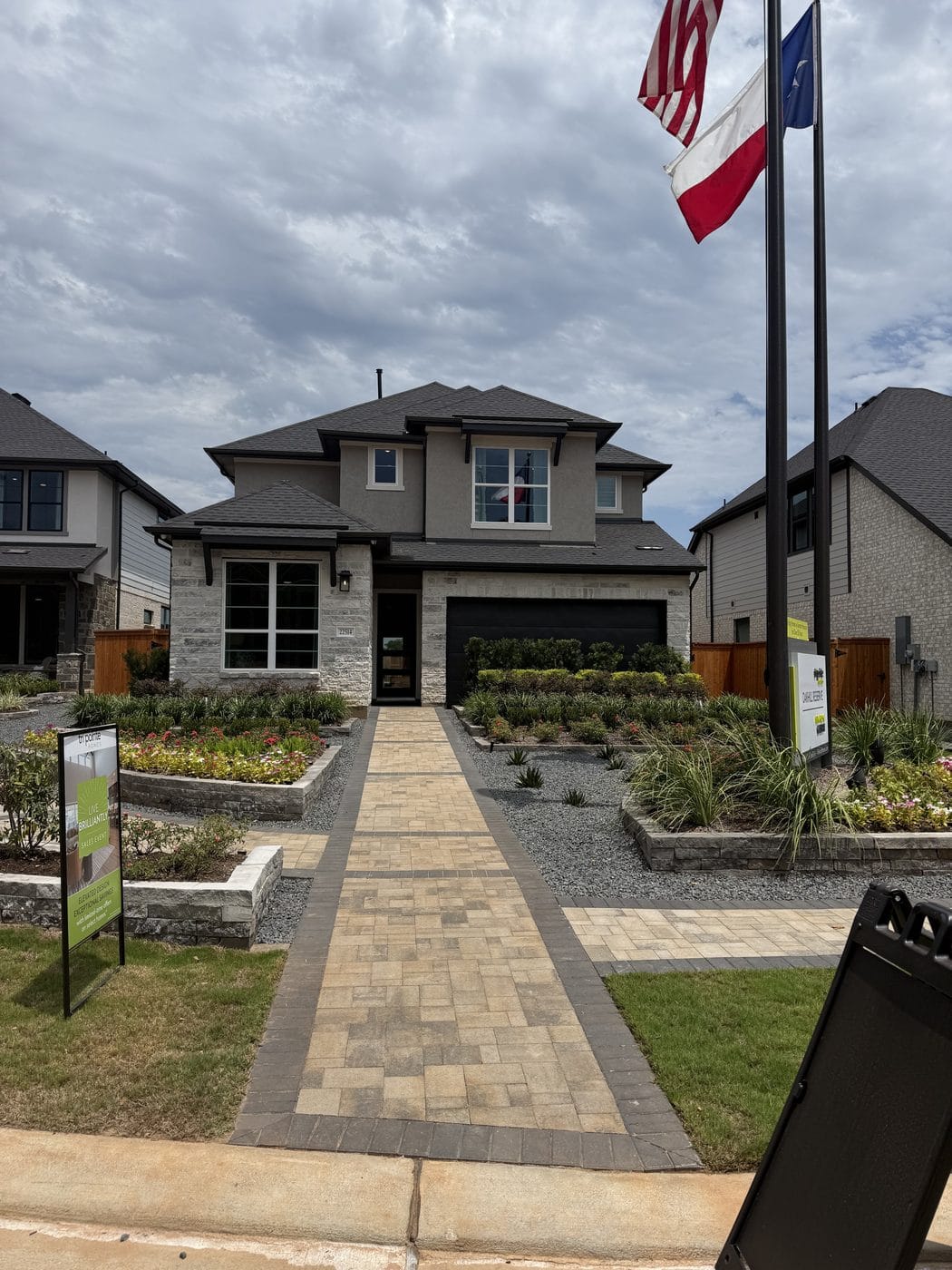 New homes in Tomball — Tri Pointe model home and flags at Oakhill Reserve