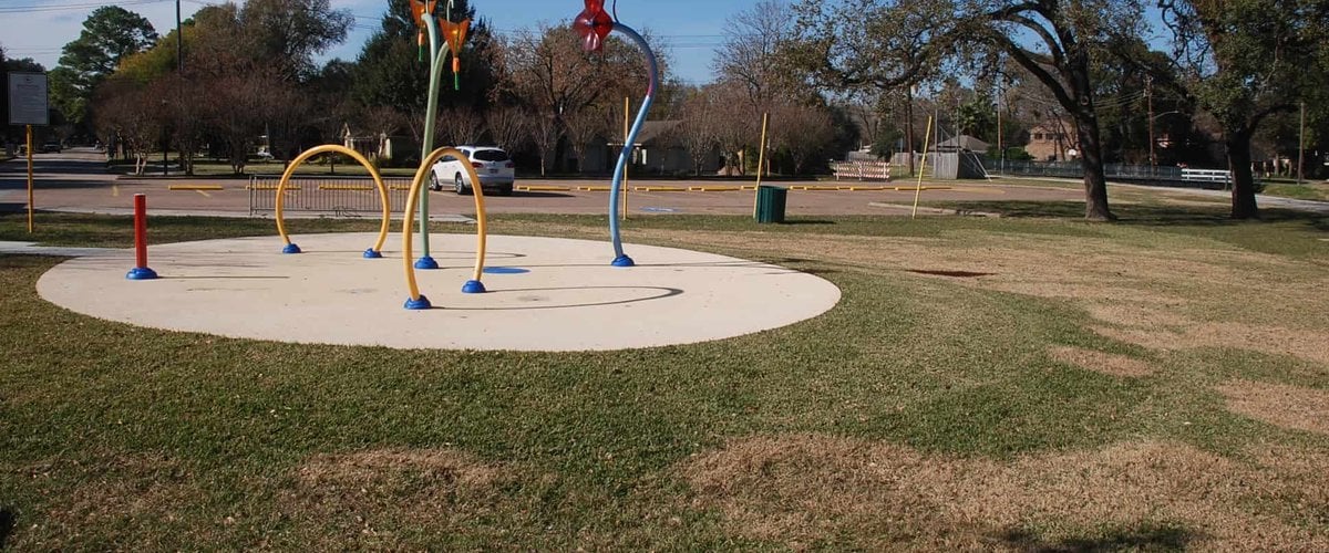 Splash pad with colorful spray arches at Clark Henry Park in Jersey Village, TX
