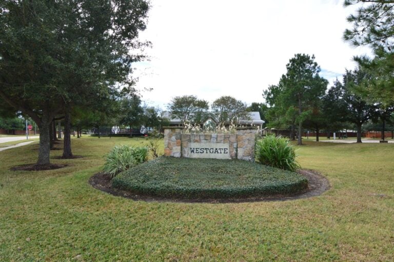 Westgate entrance monument on Westgate Park Drive in Cypress, TX 77433, with the community pool pavilion behind it