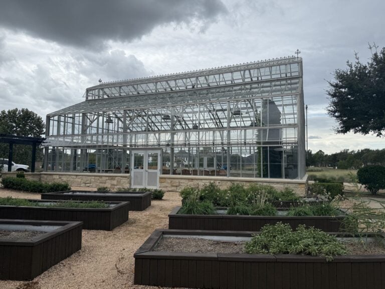 Glass-walled Conservatory with raised garden beds at Cane Quarter in Cane Island, Katy TX 77493