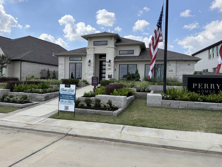 White-brick Perry Homes model with stone accents and a flagpole, Everly, Hockley TX 77447
