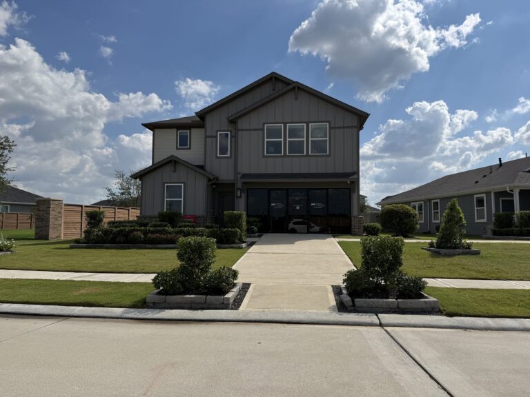 Two-story Taylor Morrison model home with board-and-batten siding in Redbud, Hockley TX 77447