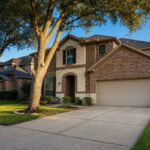 Selling your home in Katy: a two-story brick and stone home with a mature oak on a quiet Katy, TX street