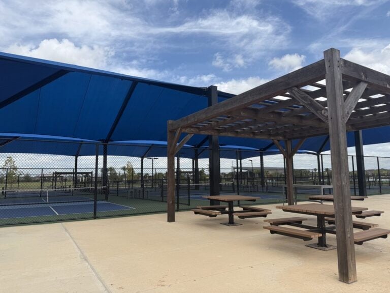 Covered pickleball courts and a shaded picnic pergola at a Sunterra park, Katy TX 77493
