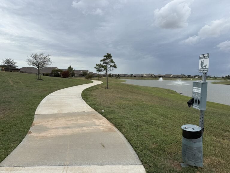 Paved trail curving along a lake in Ventana Lakes, Katy TX 77493