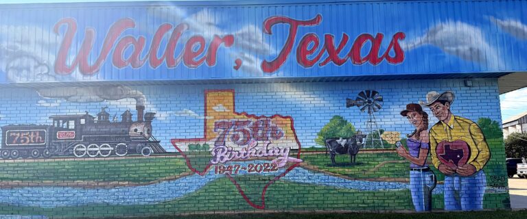 "Waller, Texas" 75th-birthday mural with a steam locomotive, windmill and Texas outline in downtown Waller, TX