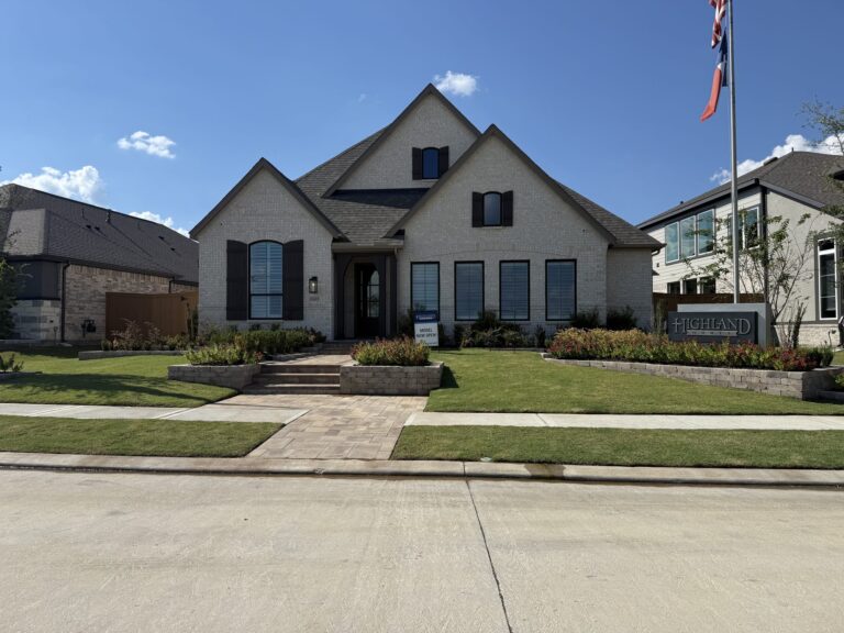 Highland Homes model with a light brick front, a stone walkway, and a flagpole, Wildrye, Waller TX 77484